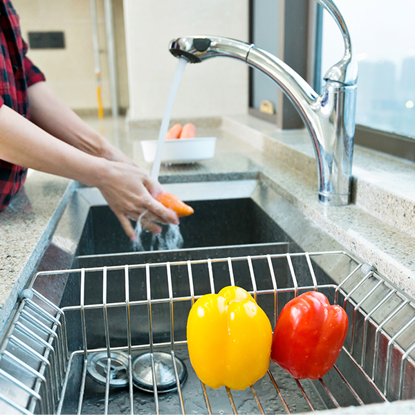 Woman washing vegetables in the kitchen